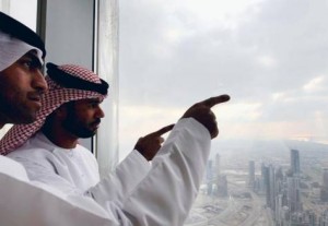 People looking out from the At The Top in Burj Khalifa yesterday. Visitors said the specially designed elevator adds to the overall experience. Image Credit: Ahmad Ramzan/Gulf News