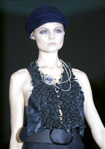 A model shows a creation part of the Giorgio Armani Spring-Summer 2011 fashion collection, during the fashion week in Milan, Italy, Monday, Sept. 27, 2010.