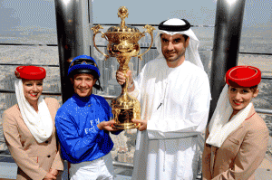 Three time Dubai World Cup winning jockey Frankie Dettori (second left) displays the Dubai World Cup trophy, with Senior Vice-President, Commercial Operations of Emirates Airlines, Ahmed Khoory (second right) on top of the Burj Khalifa in Dubai. (AP)
