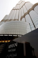 The world’s first Armani Hotel in the Burj Khalifa, the world’s tallest building, is located in Dubai, United Arab Emirates, where oil production and sales are likely to benefit from the political upheavals in neighboring countries. (Associated Press)
